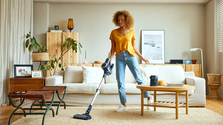 Woman vacuuming carpet