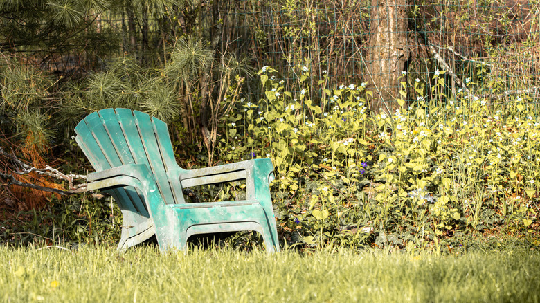 Faded plastic adirondack chair