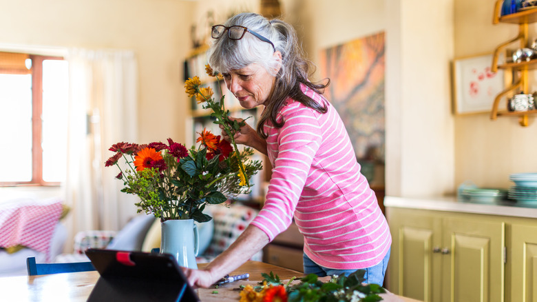 Someone arranging flowers