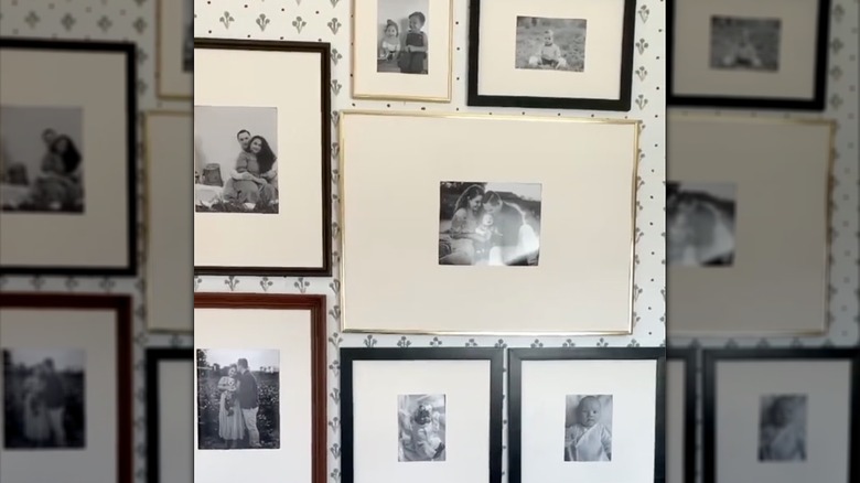 Family photo gallery wall arrangement with large white mats