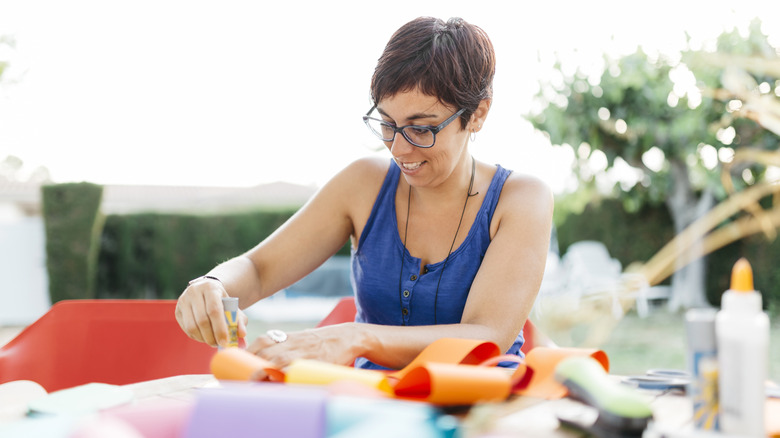 Woman crafting with glue and paper