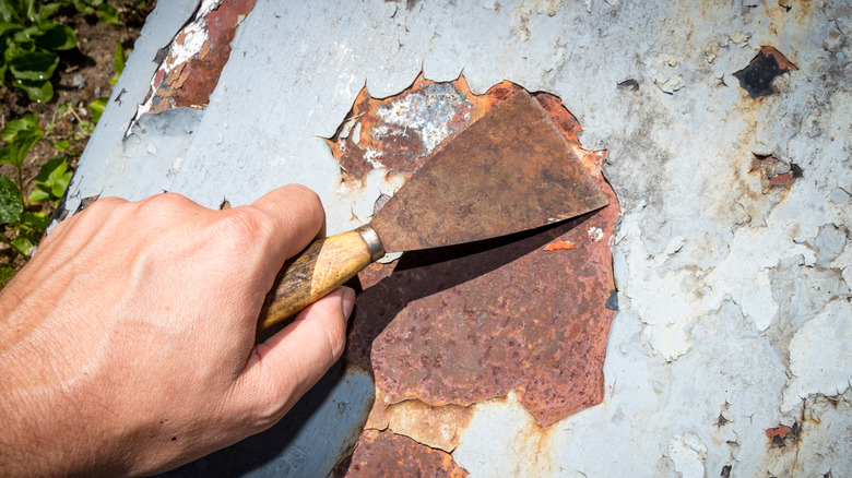 Scraping rust from metal surface