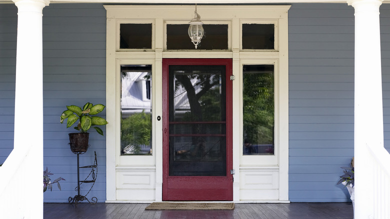 front porch with a red door