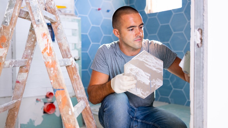 man installing tile