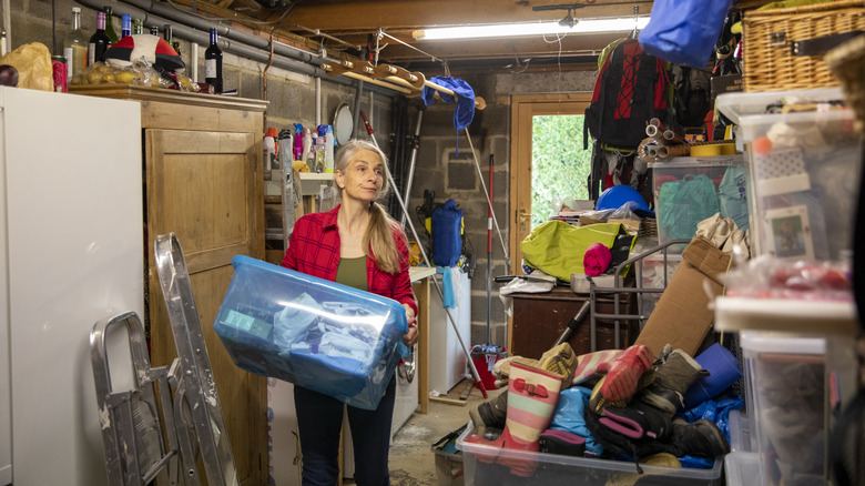 Woman holding plastic bin