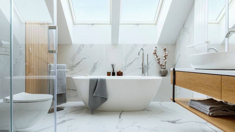 marble bathroom with white bathtub