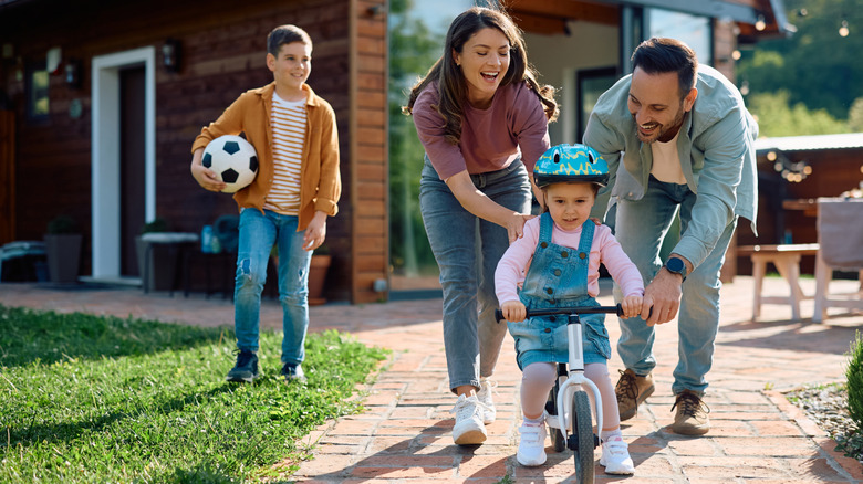 family in backyard on paver path