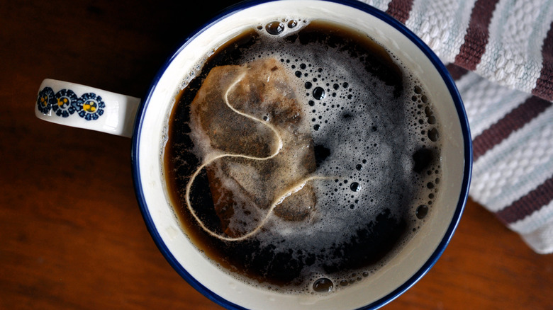 Black tea steeping in mug