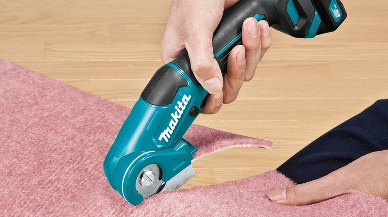 Person using the Makita Cordless Multi-Cutter Kit