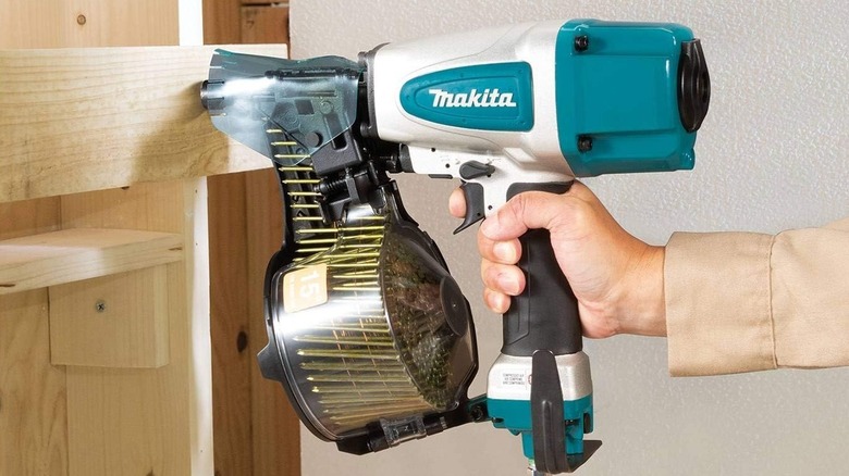 Person using the Makita 2.5-Inch Siding Coil Nailer