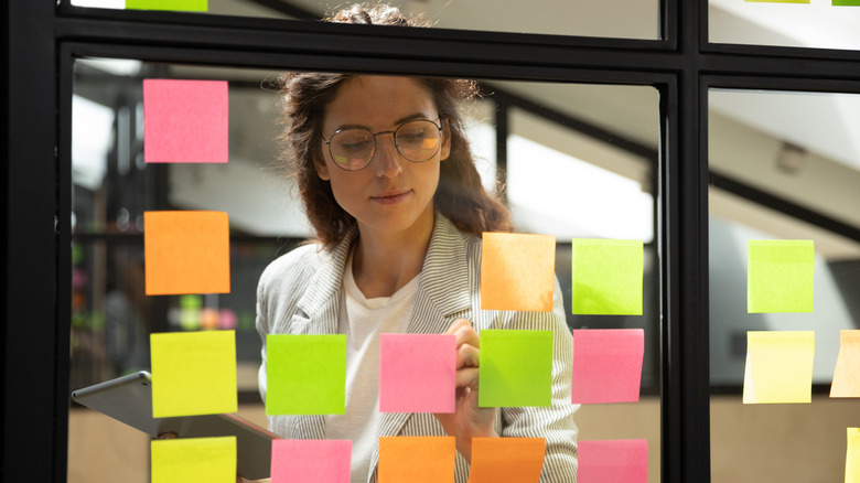 woman reading sticky notes