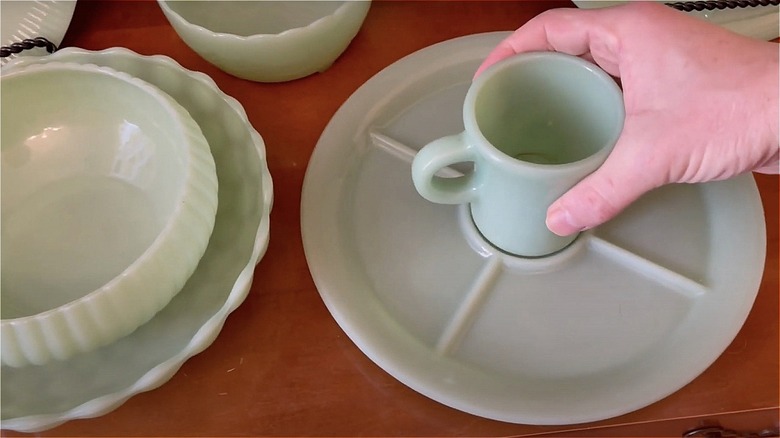 Hand holding jadeite mug