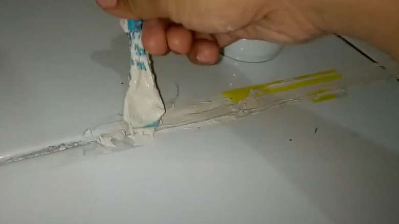 Using a spoon to re-grout