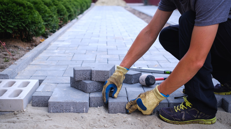 Man installing pavers