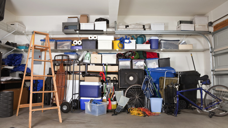 A cluttered garage utilizing vertical space for shelving