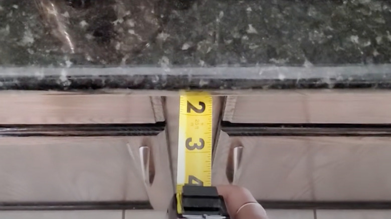 tape measure measuring countertop overhang