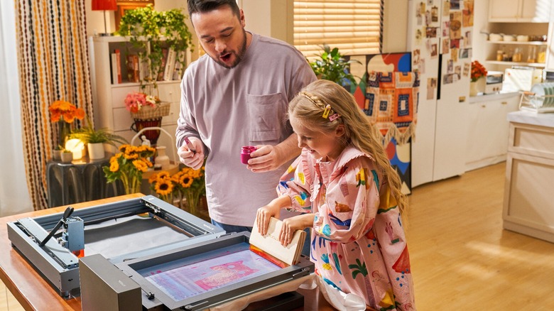 Father and daughter using xTool screen printer