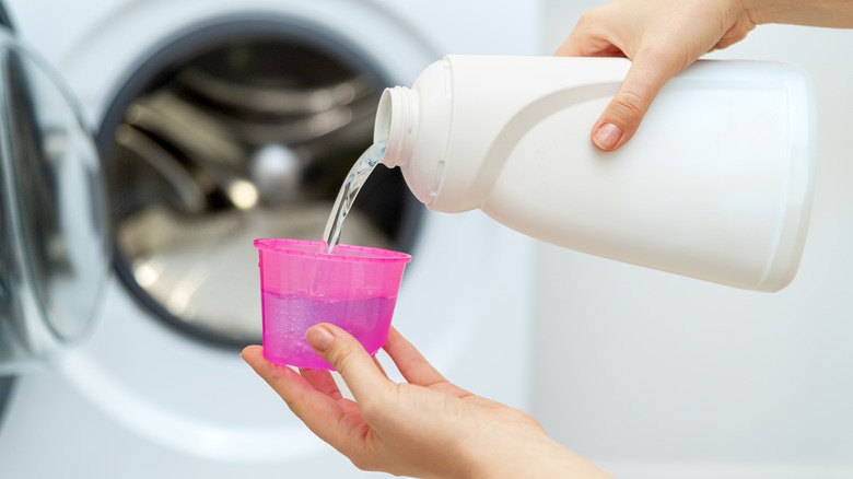 Hand pouring liquid for laundry