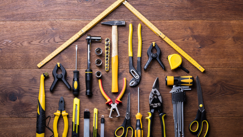 Building tools laid out in the shape of a house