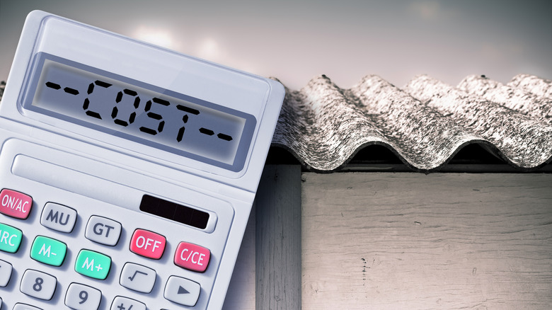 A calculator leans against metal sheets