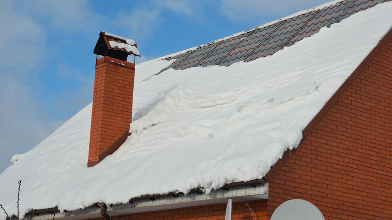 Steep metal roof covered with snow