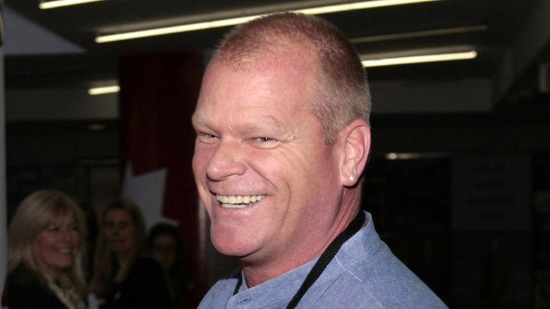 Mike Holmes smiling while meeting with people