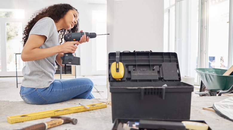 Woman assembling a drill