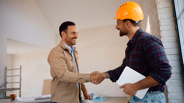 Man shaking hands with a worker in hard hat