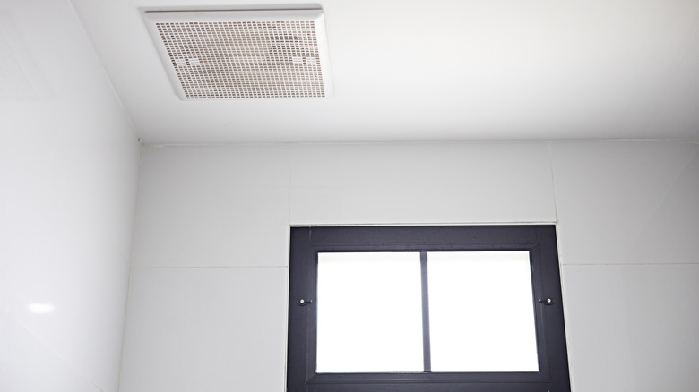 The exhaust fan is installed on the ceiling near the skylight