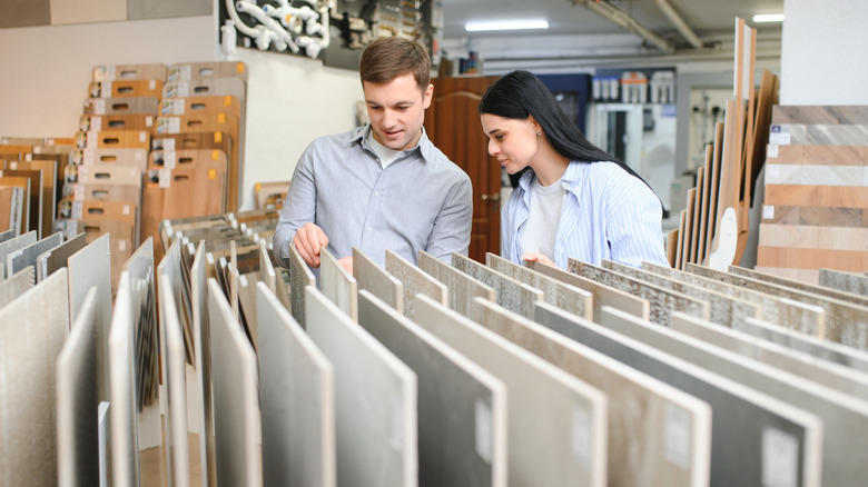 Man and woman looking at ceramic tile samples in store