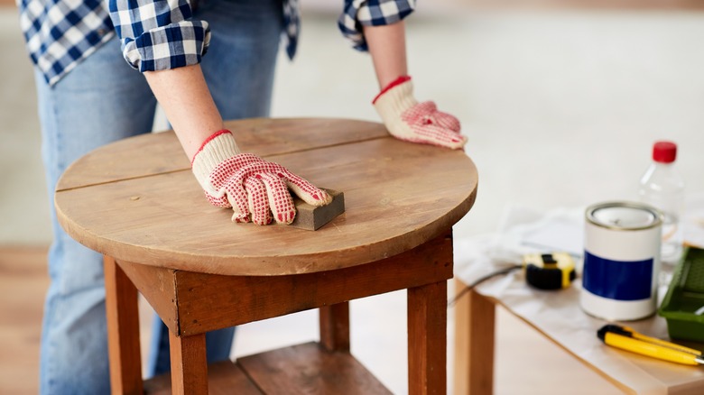 woman sanding table