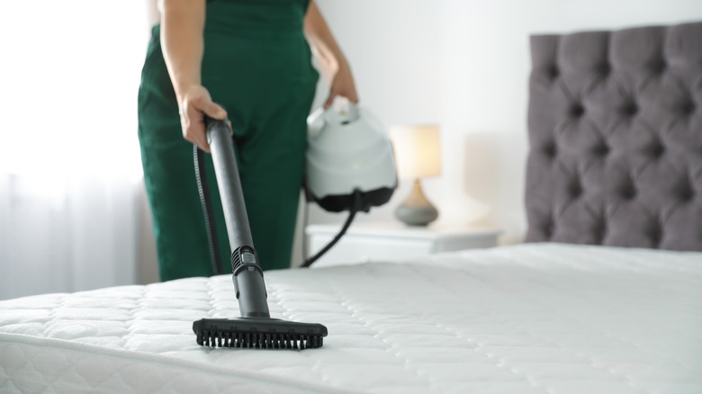 Person vacuuming the mattress