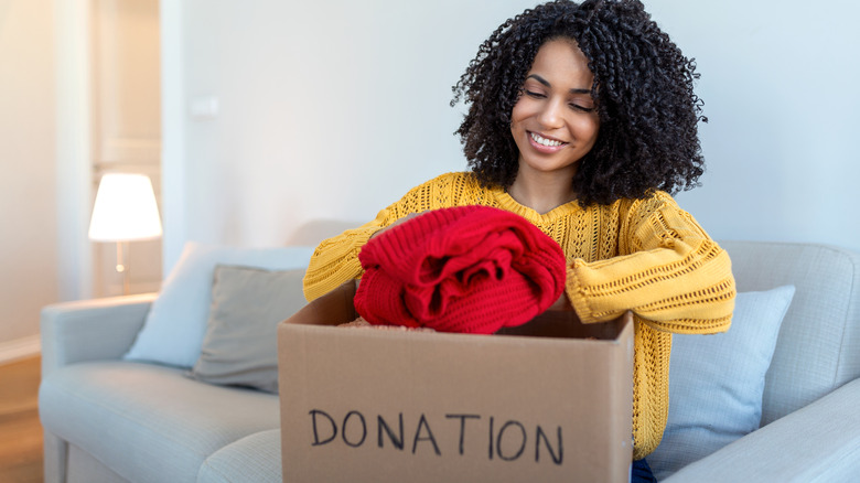 woman prepares decluttering boxes