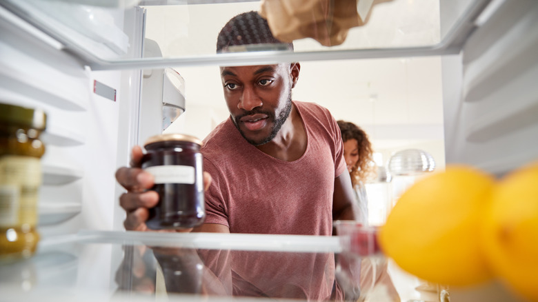 Man organizing the refrigerator