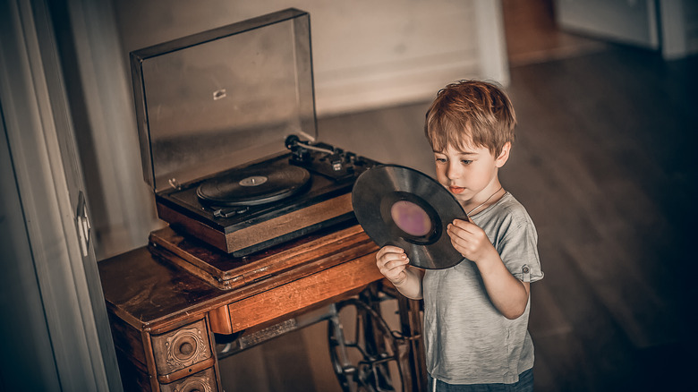 Child looking at vinyl record in wonder