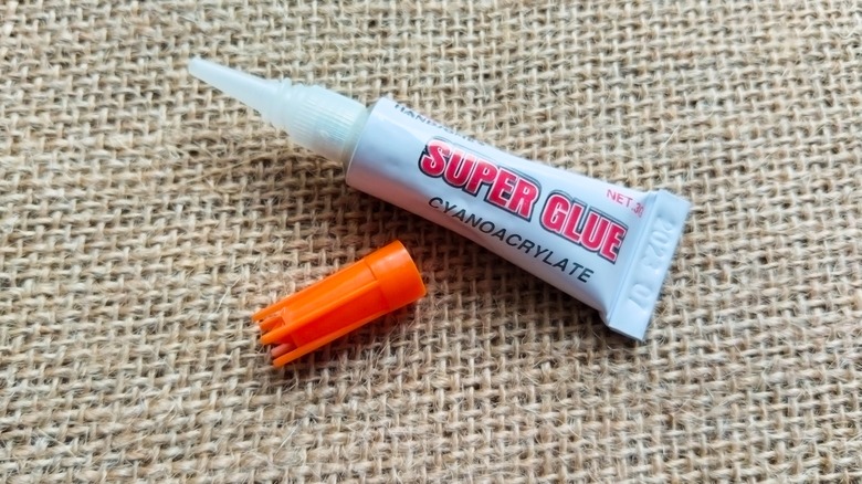 A bottle of superglue with the lid off