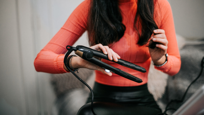 person holding flat iron