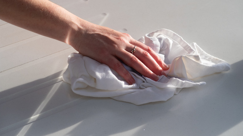 Woman cleaning quartz countertop