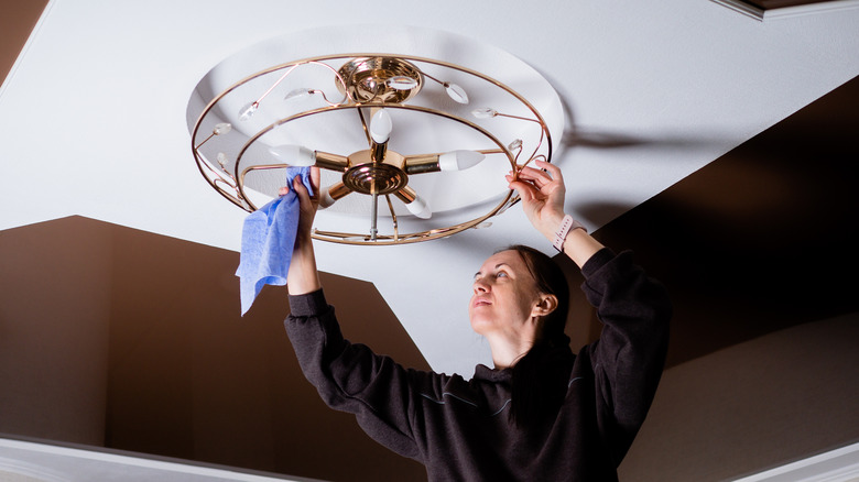 chandelier being cleaned