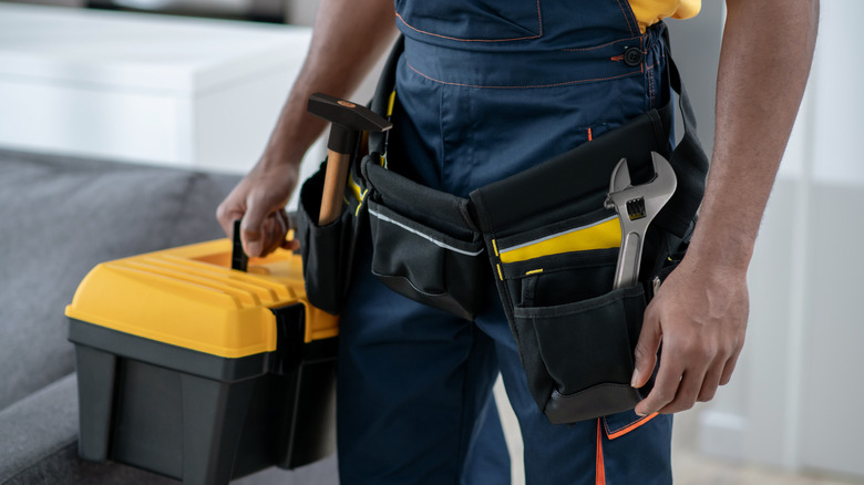 A man carrying a toolbox