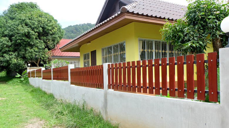 yellow house and wood fence