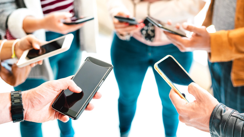 group of people with smartphones