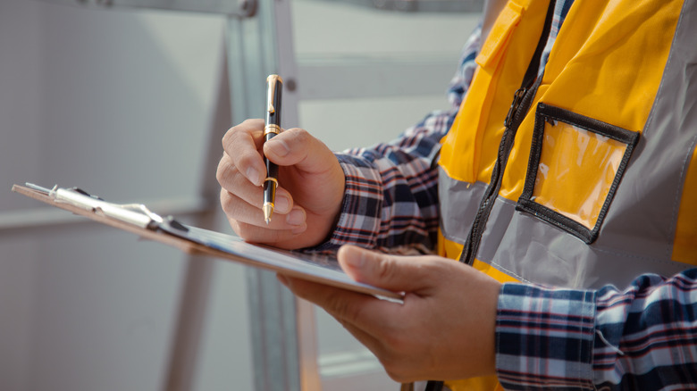 Man with clipboard and pen