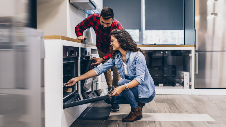 couple shopping for oven