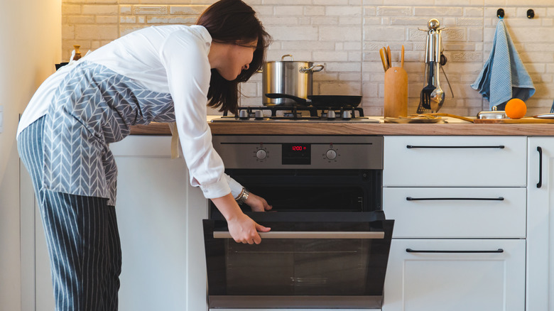 woman cooking with oven