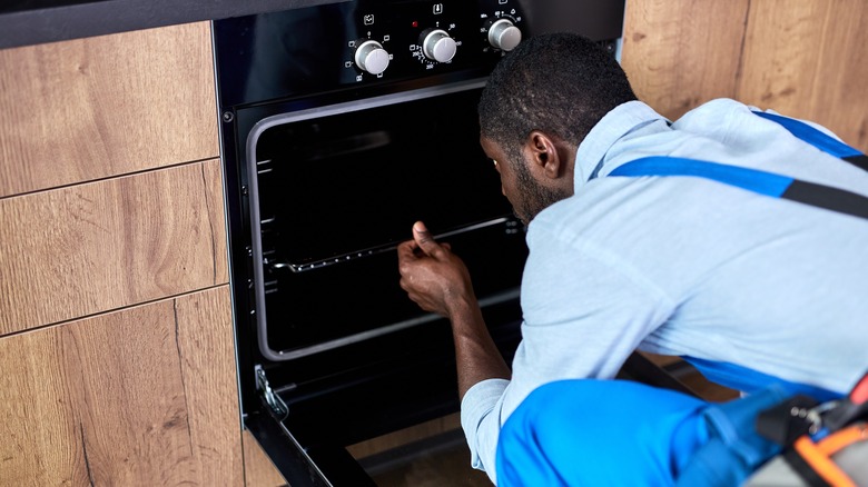 repairman fixing oven