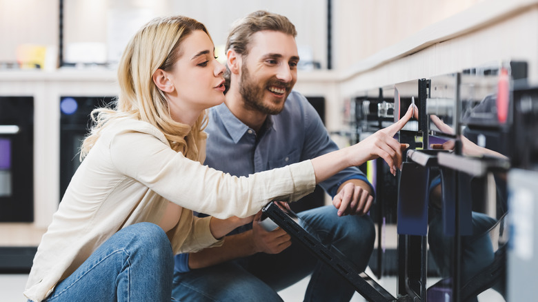 couple shopping for oven