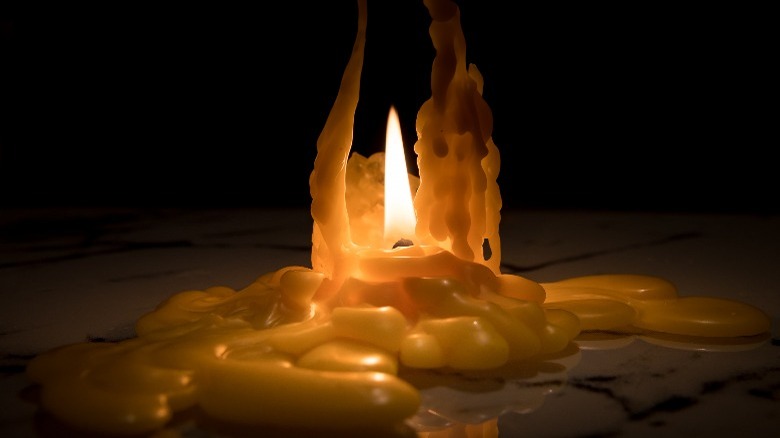 Burned down candle pooled wax