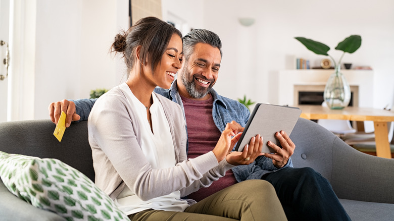 couple online shopping on tablet