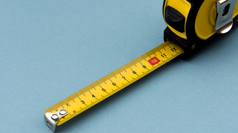 measuring tape on blue background